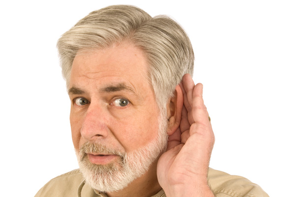 image of homeowner cupping ear to listen to whistle oil tank vent alarm during fuel delivery