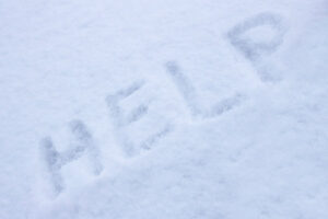 the word help in snow depicting forgetting to schedule a heating fuel delivery