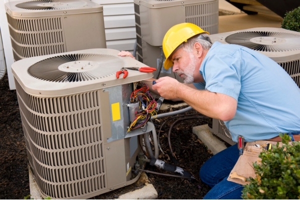 HVAC expert attending to AC unit's outdoor unit