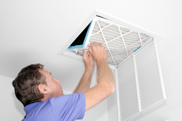 homeowner examining HVAC air filter