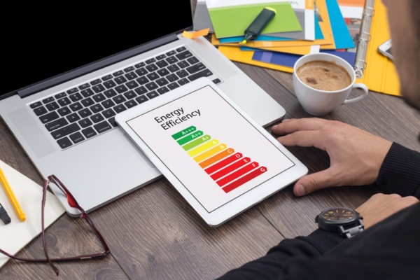 homeowner checking AC's energy efficiency on tablet