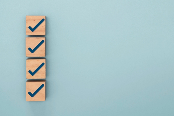 image of checkmarks on wooden blocks depicting checklist for HVAC system