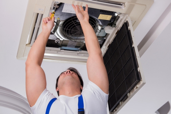 HVAC technician repairing home cooling system