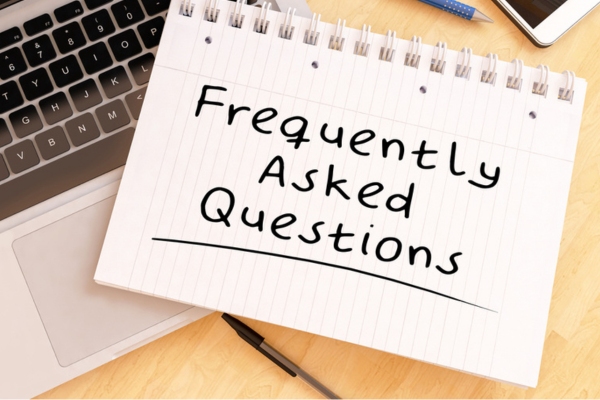 frequently asked questions written on notebook depicting air conditioner replacement FAQs