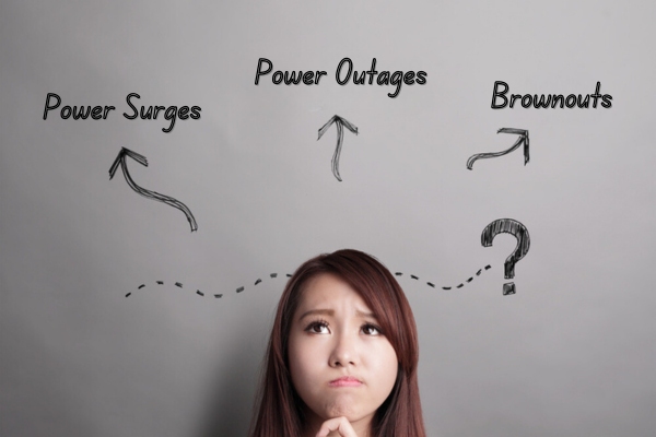 woman distinguishing the differences of power surges, power outages, and brownouts