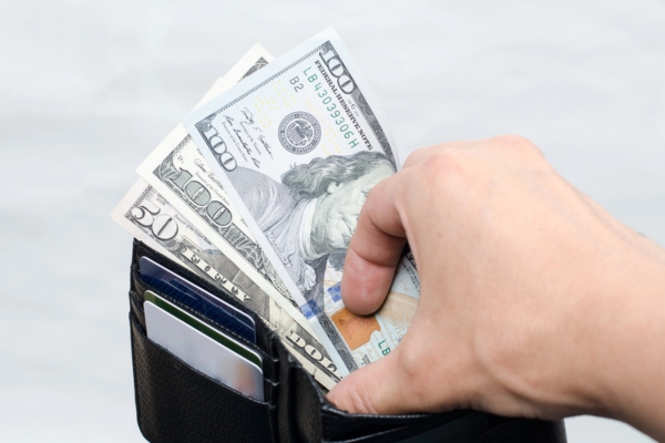 dollars in wallet depicting costs