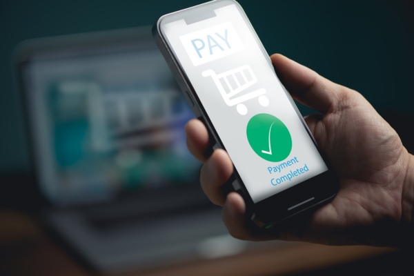 Man hand using Electronic payment on mobile phone depicting oil pricing and payment