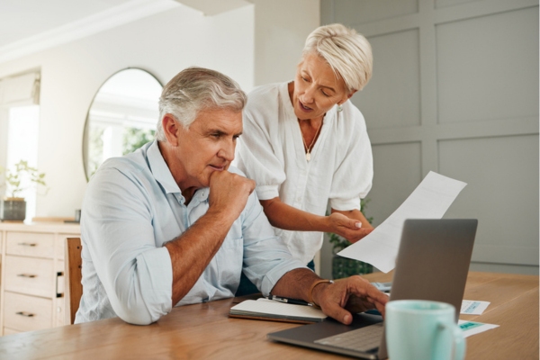 image of a couple assessing fuel expenses to decide between will call vs automatic oil delivery