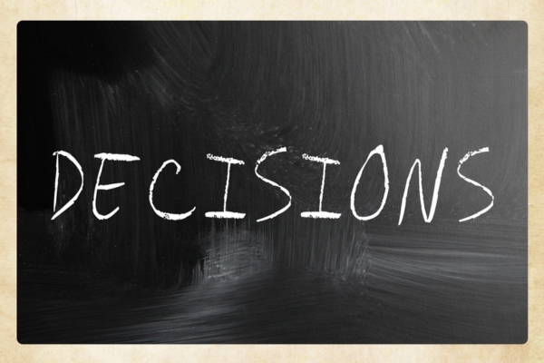 decisions word written on a chalkboard depicting choosing the right HVAC efficiency rating