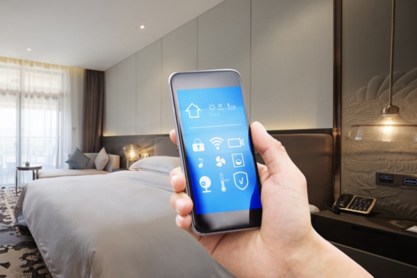 cropped view of a man's hand holding a smart phone with thermostat control for oil heating system