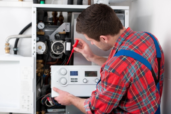 HVAC technician servicing a residential boiler