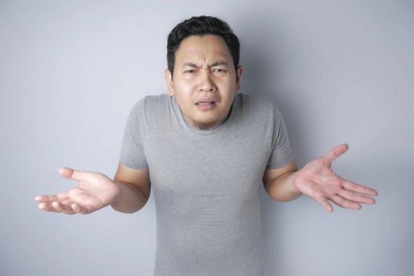 man shrugging depicting no reaction from oil-fired furnace reset button