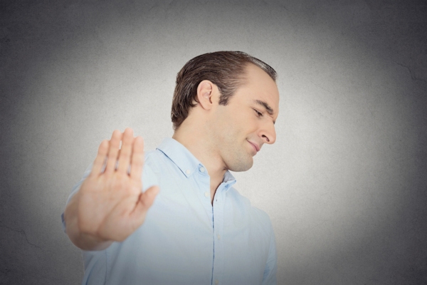 man giving talk to the hand gesture depicting ignoring air conditioner care