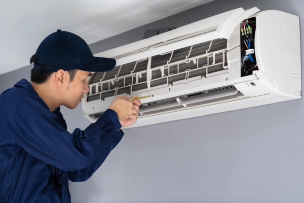 technician repairing ductless air conditioner