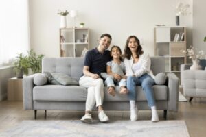 family lounging on couch while staying cool in the summer