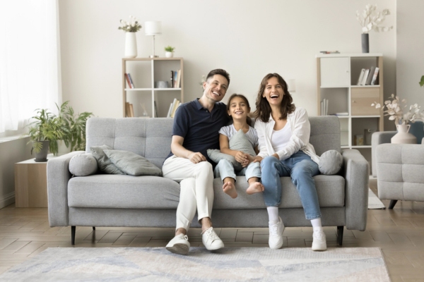 family lounging on couch while staying cool in the summer