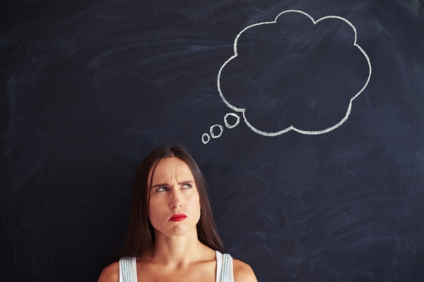 Young woman standing in front of a thought bubble doodle and frowning her brows depicting Understanding the Most Common Air Conditioner issues