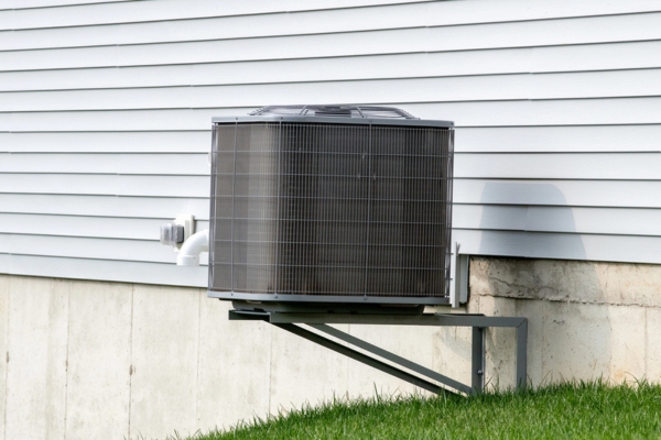outdoor ducted air conditioner unit installed at the back of the house