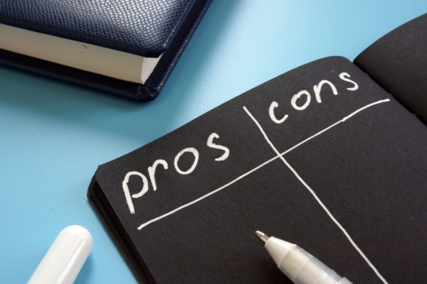 pros and cons written on a black notebook depicting Central and Ductless Cooling Systems