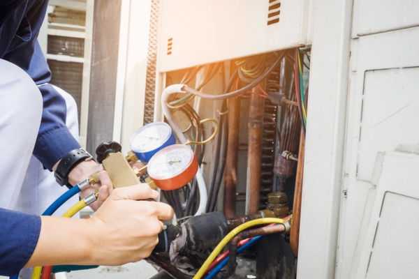 HVAC Technician is checking air conditioner electrical problem