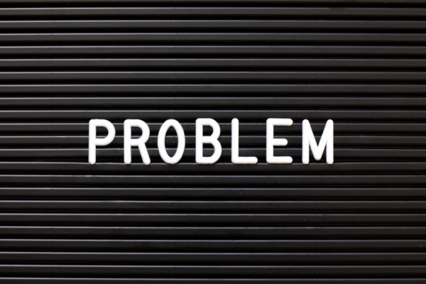 PROBLEM spelled using felt letters on a black board depicting problems solved by fuel oil additives