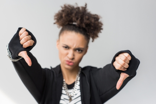 girl doing thumbs down depicting Drawbacks of Using Fuel Oil Additives