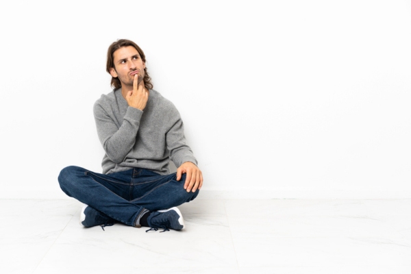 man sitting on the floor while thinking about the Purpose of Heating Oil Treatments