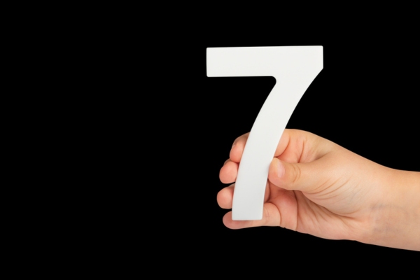 number 7 held by a man's hand depicting Furnace Prep Steps