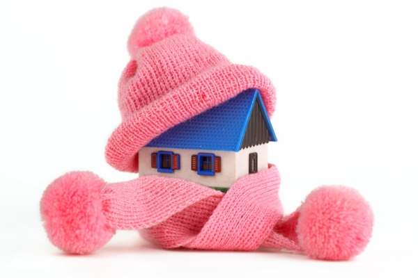 miniature home with scarf and beanie depicting home heating