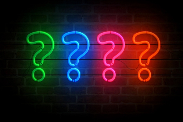 question marks made of neon lights depicting FAQs About Oil-Fired Hydronic Heating