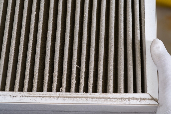 homeowner removing dirty HVAC air filter