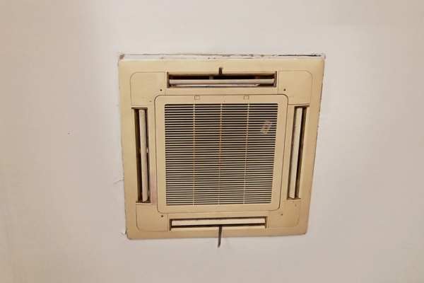 Aging central air conditioner cover above the ceiling of the house