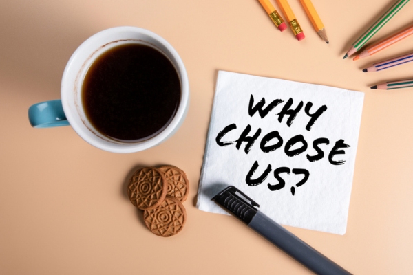 Why choose us handwritten note on a table