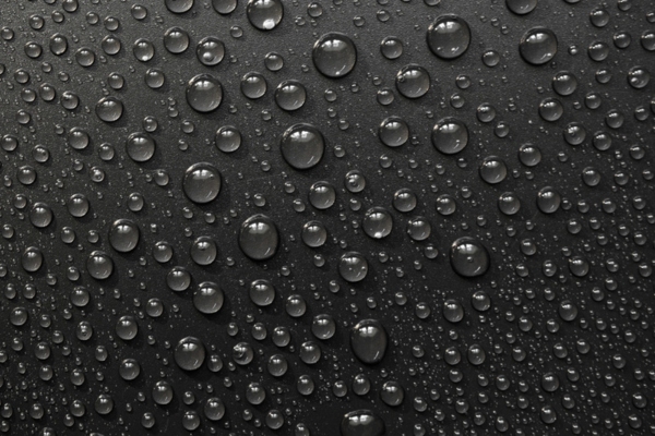 condensation on a black surface depicting The Effects of Summer Heat and Humidity on Fuel Oil Tanks