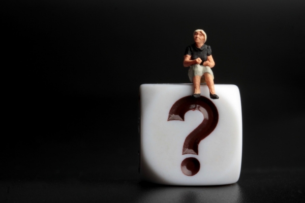 miniature figurine of a woman sitting on top of a dice with question mark depicting Comfort Air Conditioner FAQs
